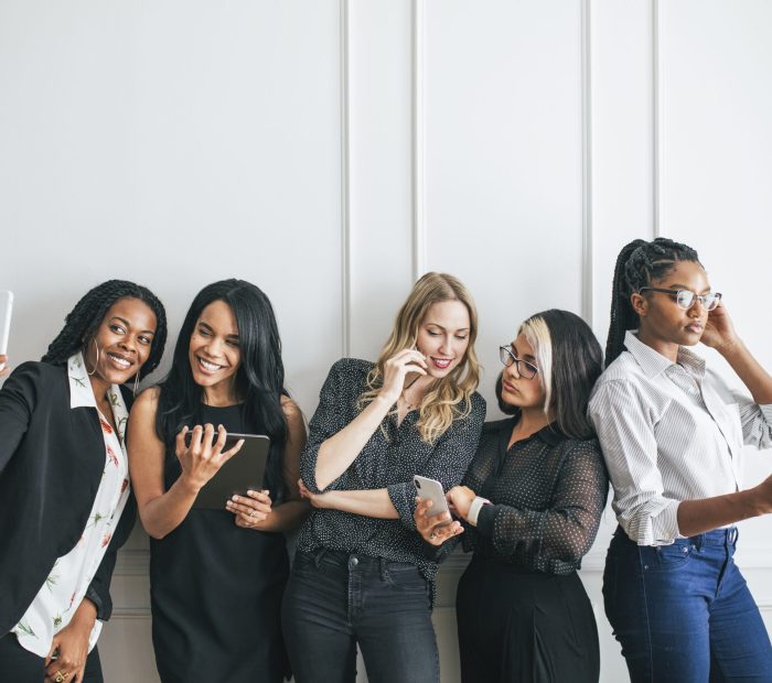 Diverse businesswomen using digital devices